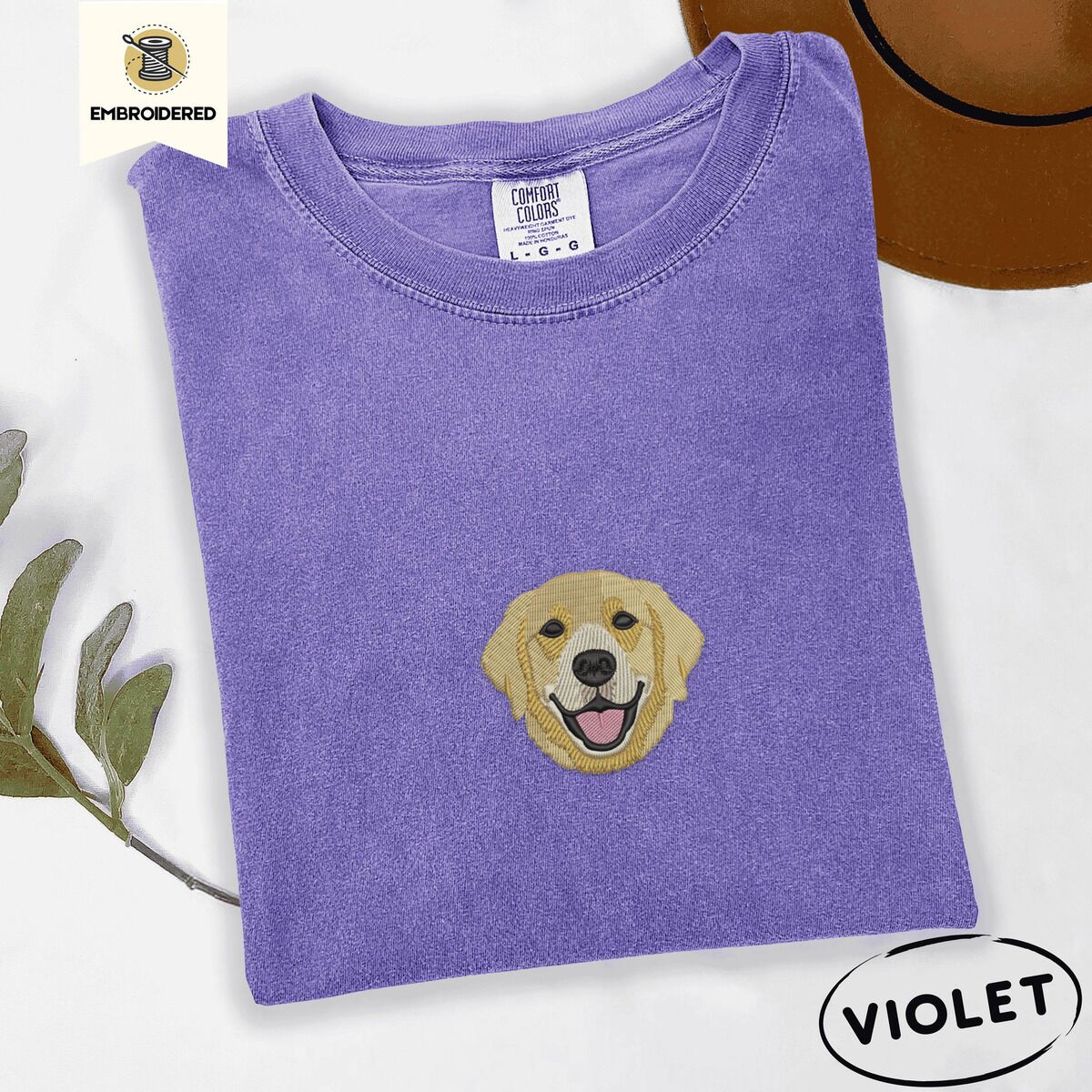 Golden Retriever Face Shirt – Violet Violet Comfort Colors T-shirt embroidered with a smiling golden retriever face with a pink tongue