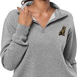 Woman holding the collar of a heather grey quarter zip embroidered with a small sitting golden retriever on the left chest