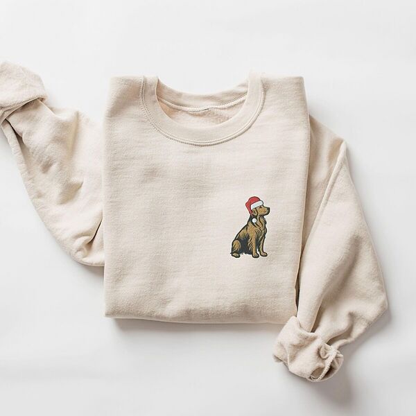 Golden retriever Santa sweatshirt in Sand laid flat with rolled cuffs, embroidered with a small golden retriever in a red Santa hat on the left chest