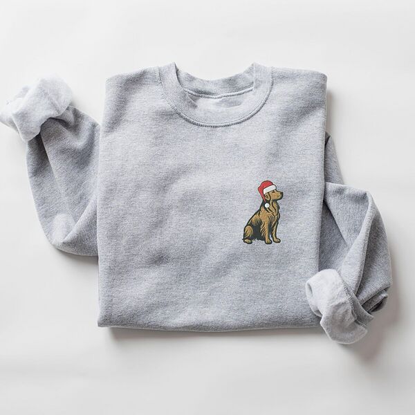 Sport Grey crewneck sweatshirt laid flat, embroidered with a small golden retriever sitting in a red Santa hat on the left chest