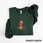 Forest Green crewneck sweatshirt laid flat, embroidered with a golden doodle in a Santa hat and red scarf between two presents