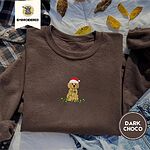 Dark Chocolate crewneck sweatshirt on a plaid flannel shirt with yellow autumn leaves and denim shorts, embroidered with a goldendoodle puppy in a Santa hat chewing on a tangled string of Christmas lights