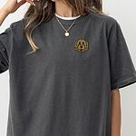 Woman in an oversized Pepper T-shirt embroidered with a golden doodle face on the left chest