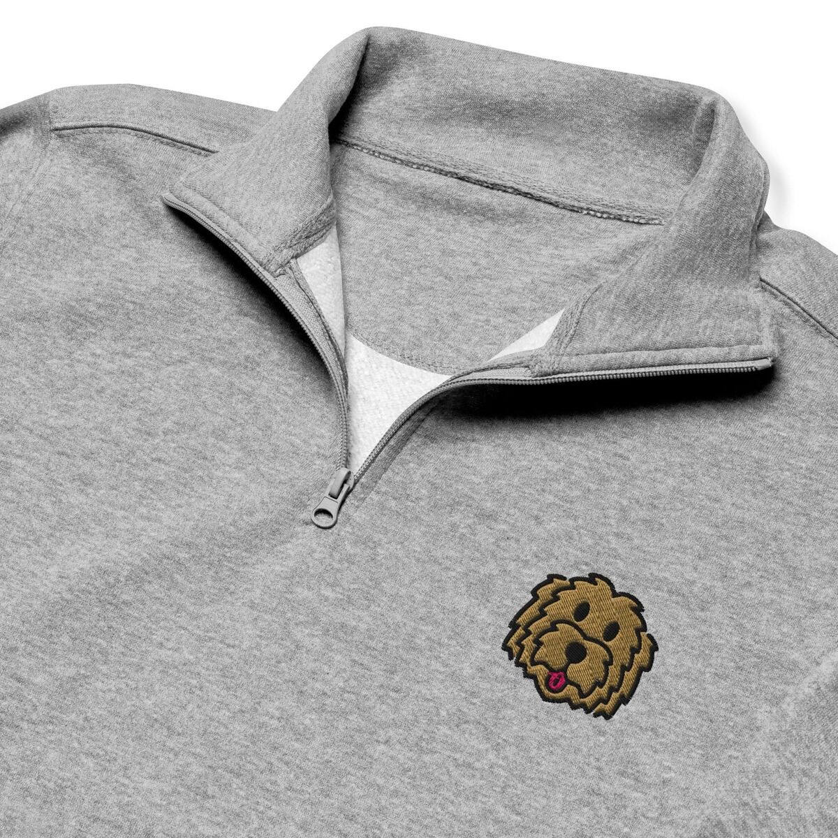 Goldendoodle Quarter Zip - close-up Close-up of a heather grey quarter zip collar, embroidered with a shaggy golden doodle face on the left chest