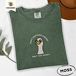 Moss Comfort Colors T-shirt embroidered with a cool white goose in black sunglasses with arched white lettering embroidered on the chest