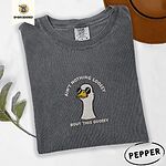 Pepper Comfort Colors T-shirt embroidered with a cool white goose in black sunglasses with arched white lettering embroidered on the chest