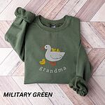 Military Green crewneck sweatshirt folded on a wooden floor, embroidered with a white mama duck, yellow ducklings and the word grandma in white thread