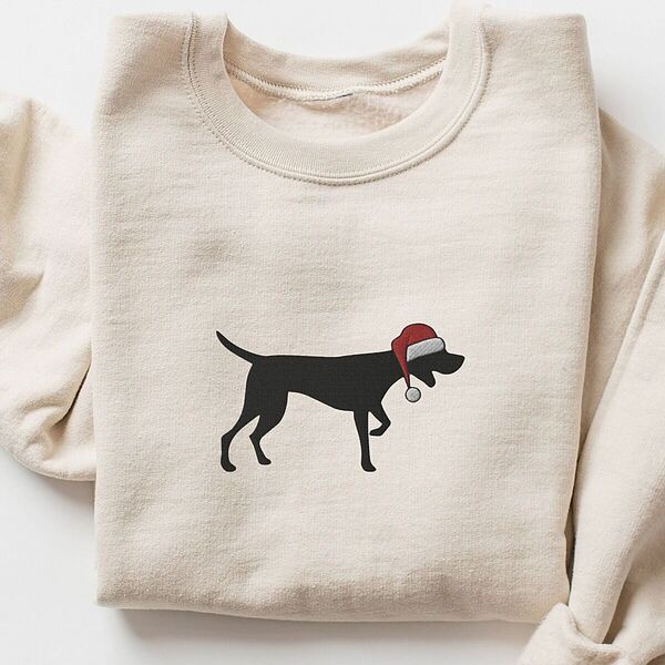 Sand crewneck sweatshirt laid flat on a white background, embroidered with a black German shorthaired pointer silhouette in a red Santa hat