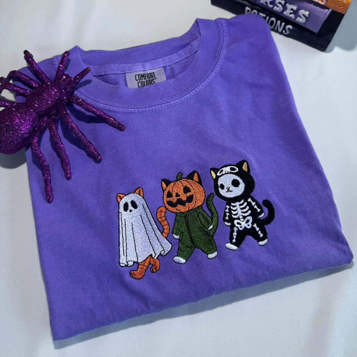 Halloween Cat Shirt – Folded Violet Tee Folded violet Halloween cat shirt with three embroidered costume cats