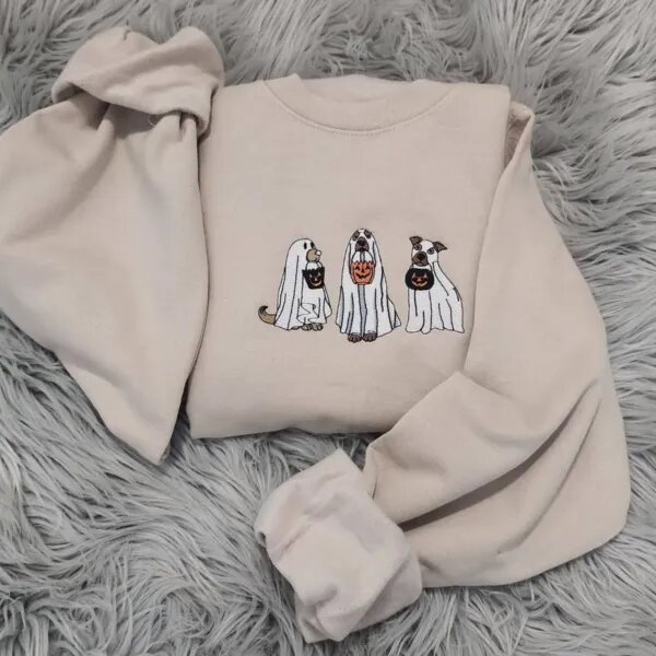 Sand Halloween crewneck with three trick-or-treating ghost dogs embroidered across the chest, sleeves spread out