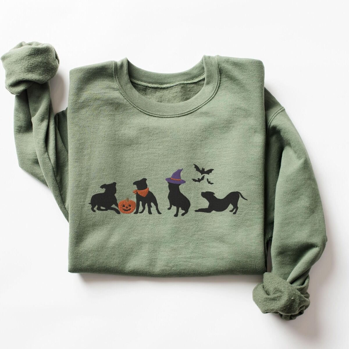 Halloween Pitbull Sweatshirt – Military Green Military Green crewneck sweatshirt laid flat on a white background, embroidered with four black pit bull silhouettes with a jack-o'-lantern, an orange bandana, a purple witch hat and bats