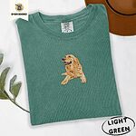 Light Green Comfort Colors T-shirt embroidered with a happy golden retriever lying down with its head up and tongue out