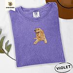 Violet Comfort Colors T-shirt embroidered with a happy golden retriever lying down with its head up and tongue out