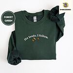 Forest Green crewneck sweatshirt folded on a white background, embroidered with three mallard ducks flying under the arched words He leads. I follow. in white thread