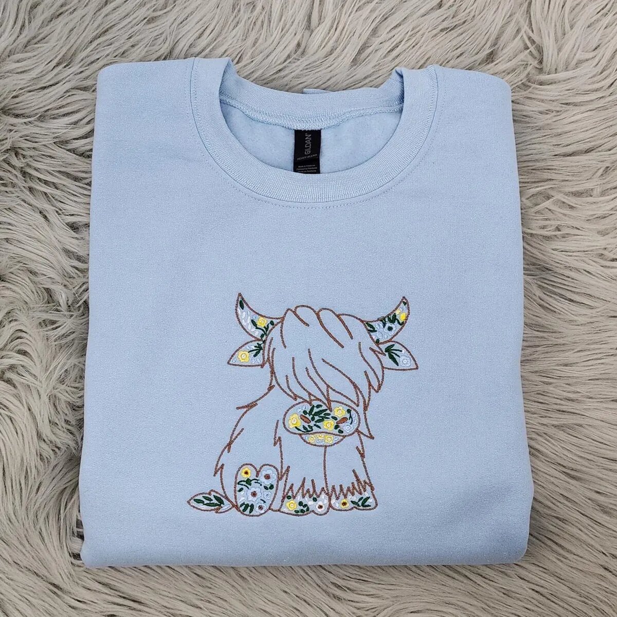 Highland Cow Crewneck – Light Blue Light Blue Highland cow crewneck with the embroidered floral Highland cow centered on the chest