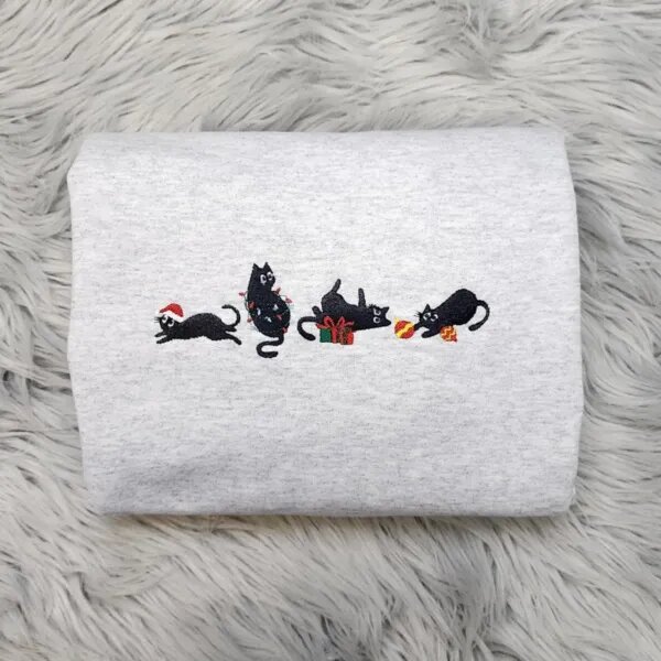 Holiday cat sweatshirt in light heather grey with four embroidered black cats, a Santa hat, Christmas lights, a gift box and ornaments