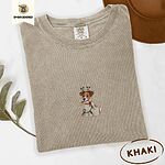 Khaki Comfort Colors T-shirt embroidered with a white and tan Jack Russell puppy in a reindeer headband chewing a string of Christmas lights