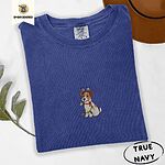 True Navy Comfort Colors T-shirt embroidered with a white and tan Jack Russell puppy in a reindeer headband chewing a string of Christmas lights