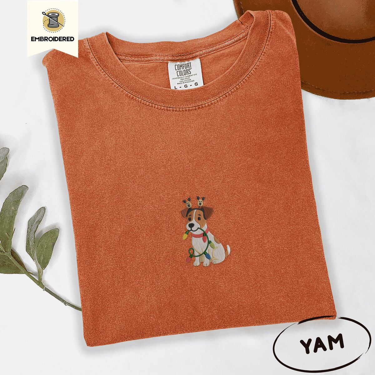 Jack Russell Christmas Lights Shirt – Yam Yam Comfort Colors T-shirt embroidered with a white and tan Jack Russell puppy in a reindeer headband chewing a string of Christmas lights
