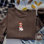 Dark Chocolate Jack Russell Christmas sweatshirt on a plaid flannel shirt with yellow autumn leaves and denim shorts, with a mini embroidered Jack Russell puppy in a Santa hat and red scarf centered on the chest