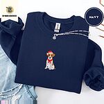 Navy Jack Russell Christmas sweatshirt folded with ripped jeans and a silver chain necklace, with a mini embroidered Jack Russell puppy in a Santa hat and red scarf centered on the chest