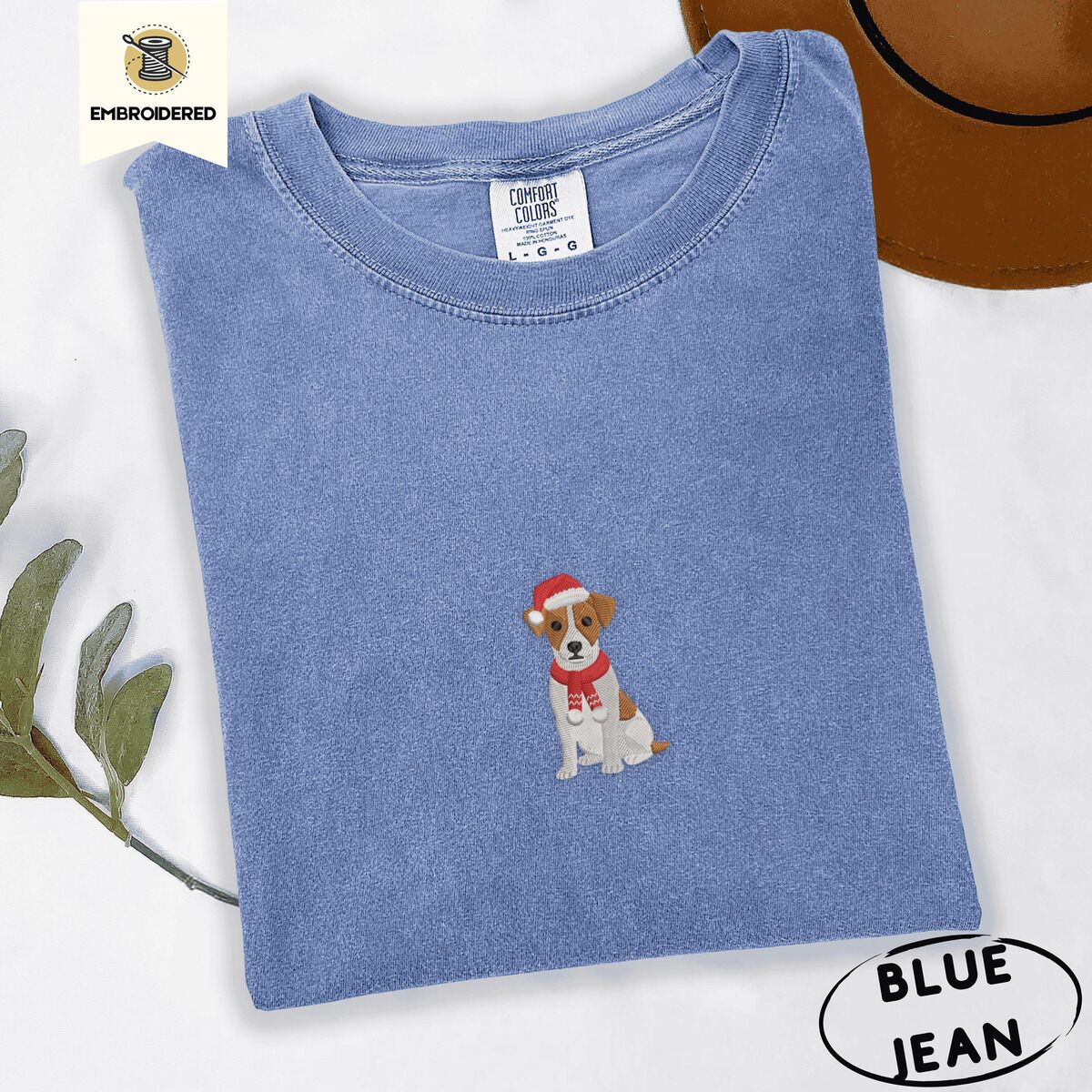 Jack Russell Santa Hat Shirt – Blue Jean Blue Jean Comfort Colors T-shirt embroidered with a mini Jack Russell Terrier puppy in a red Santa hat and a knitted red scarf