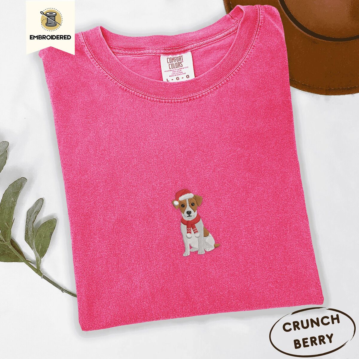 Jack Russell Santa Hat Shirt – Crunchberry Crunchberry Comfort Colors T-shirt embroidered with a mini Jack Russell Terrier puppy in a red Santa hat and a knitted red scarf