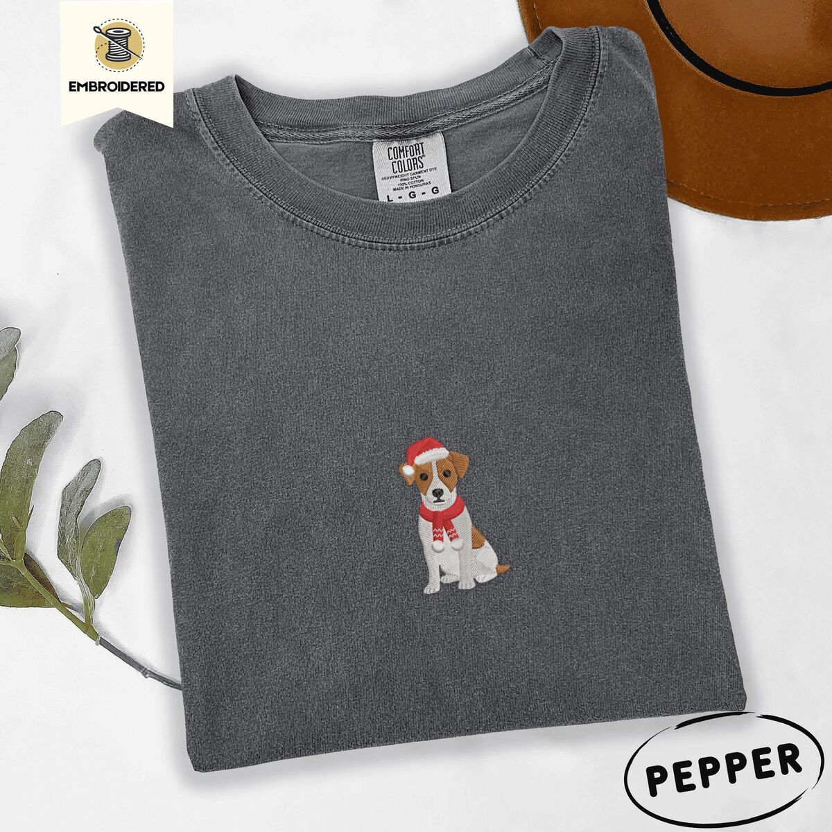 Jack Russell Santa Hat Shirt – Pepper Pepper Comfort Colors T-shirt embroidered with a mini Jack Russell Terrier puppy in a red Santa hat and a knitted red scarf