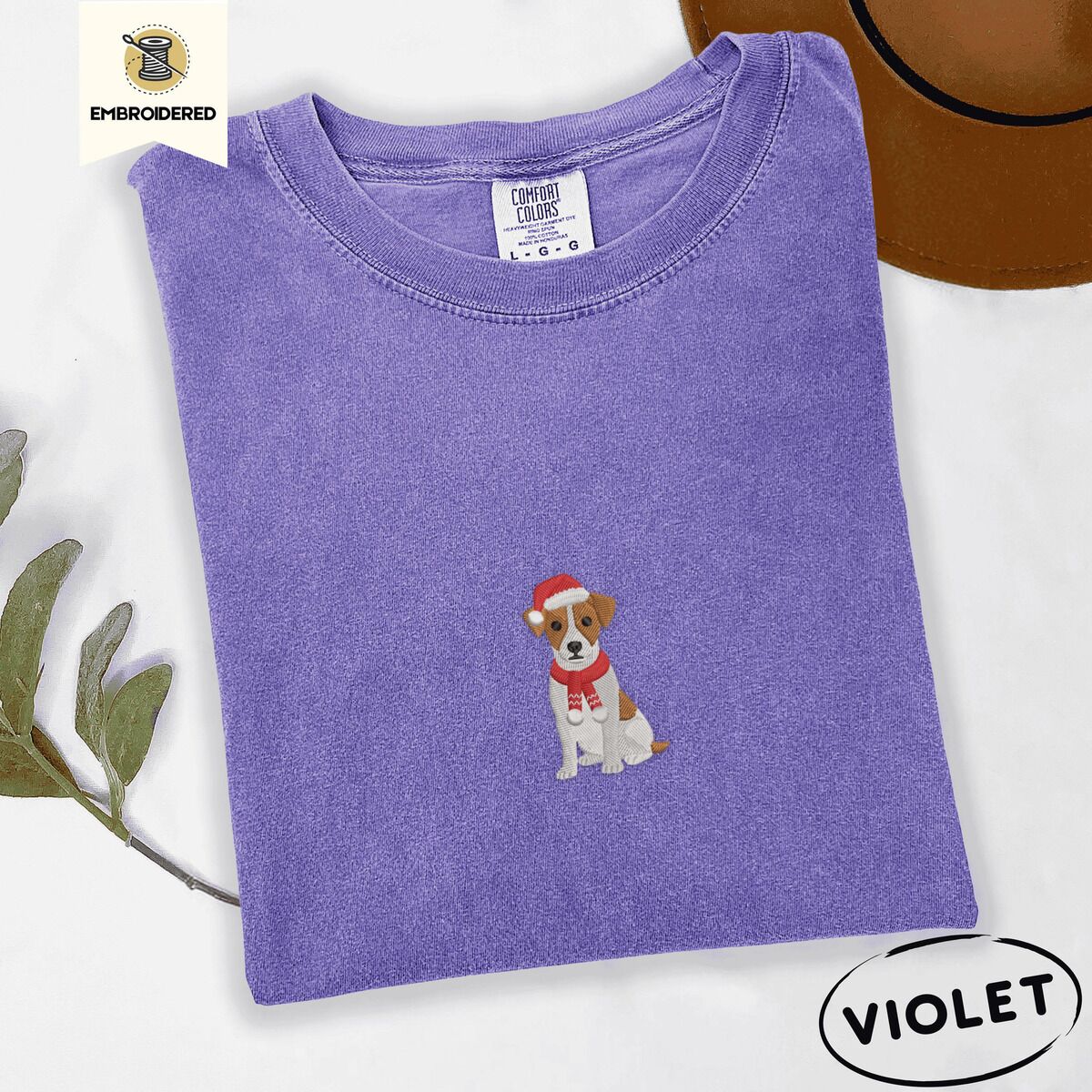Jack Russell Santa Hat Shirt – Violet Violet Comfort Colors T-shirt embroidered with a mini Jack Russell Terrier puppy in a red Santa hat and a knitted red scarf