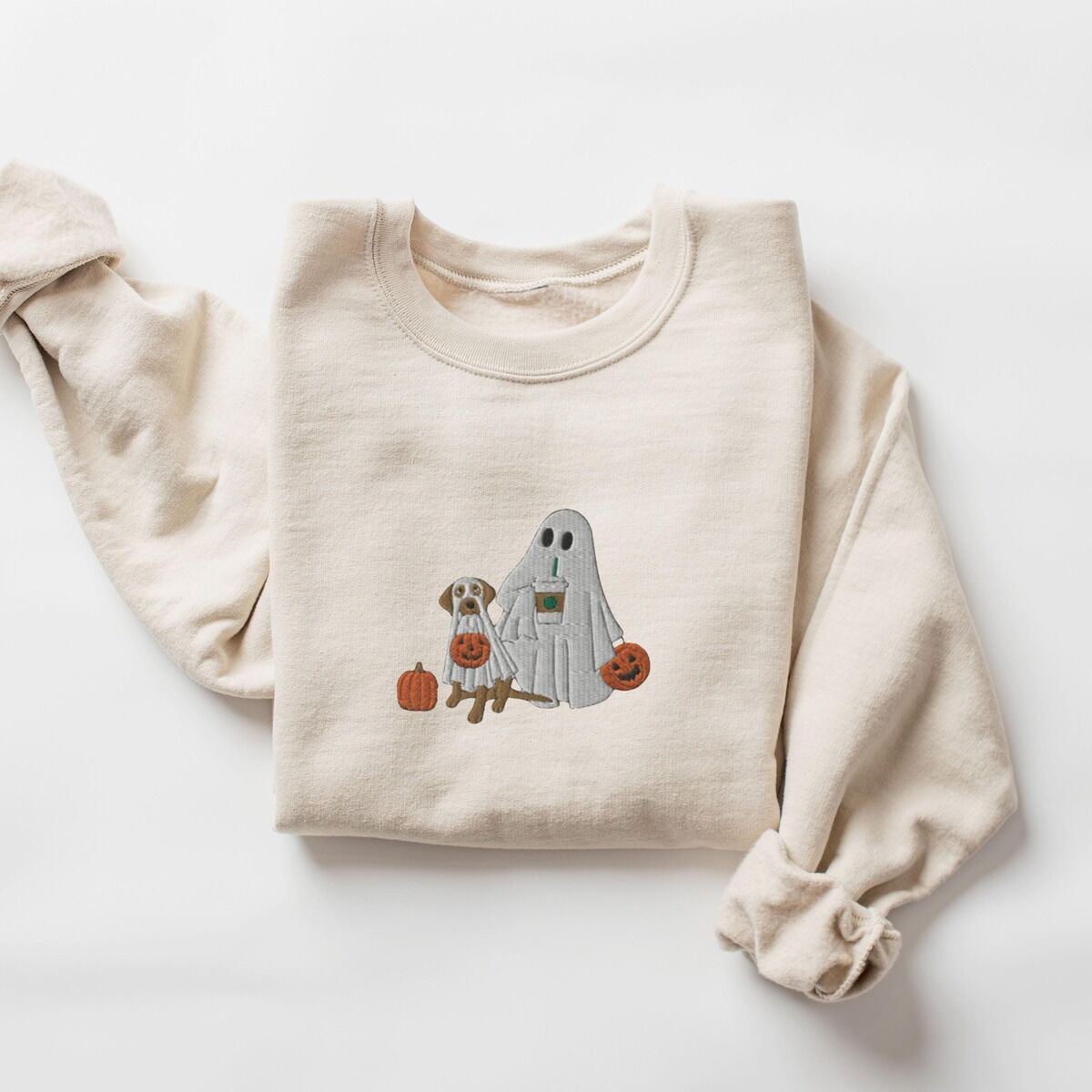 Lab Mom Ghost Sweatshirt – Sand Sand crewneck sweatshirt laid flat on a white background, embroidered with a ghost lab mom holding a coffee cup and a jack-o'-lantern pail beside a tan lab in a ghost sheet with its own pumpkin pail