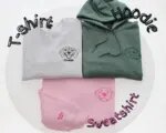 The line art pet portrait on a grey T-shirt, a green hoodie and a pink sweatshirt with the name Rocky and a bone on the sleeve