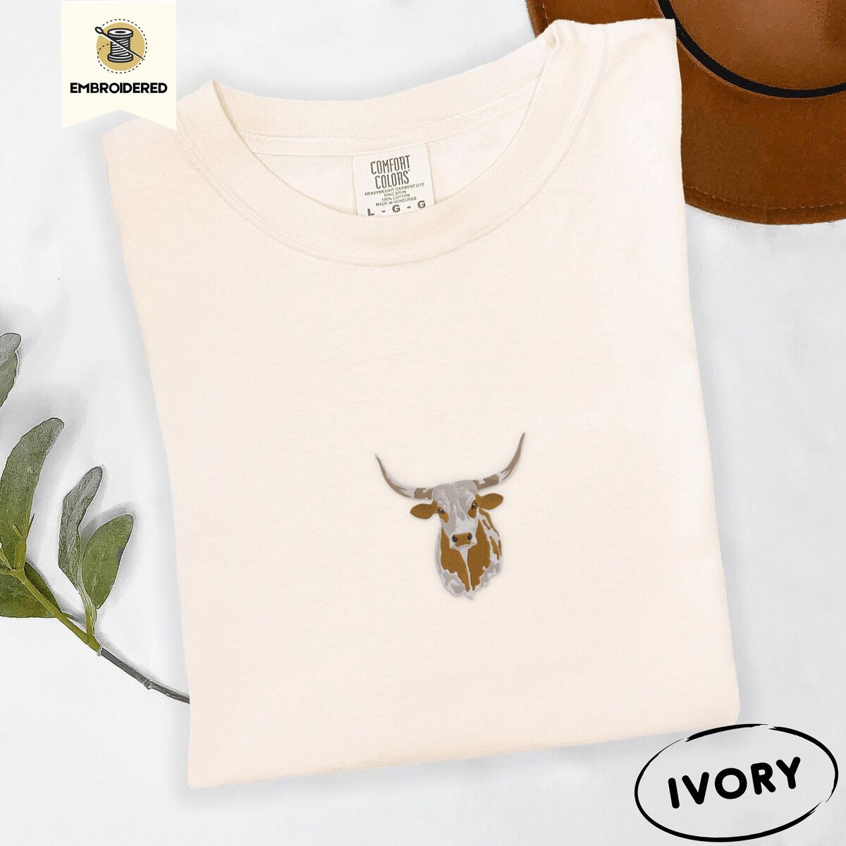 Longhorn Cow Shirt – Ivory Ivory Comfort Colors T-shirt embroidered with a copper and cream longhorn steer head with long curved horns