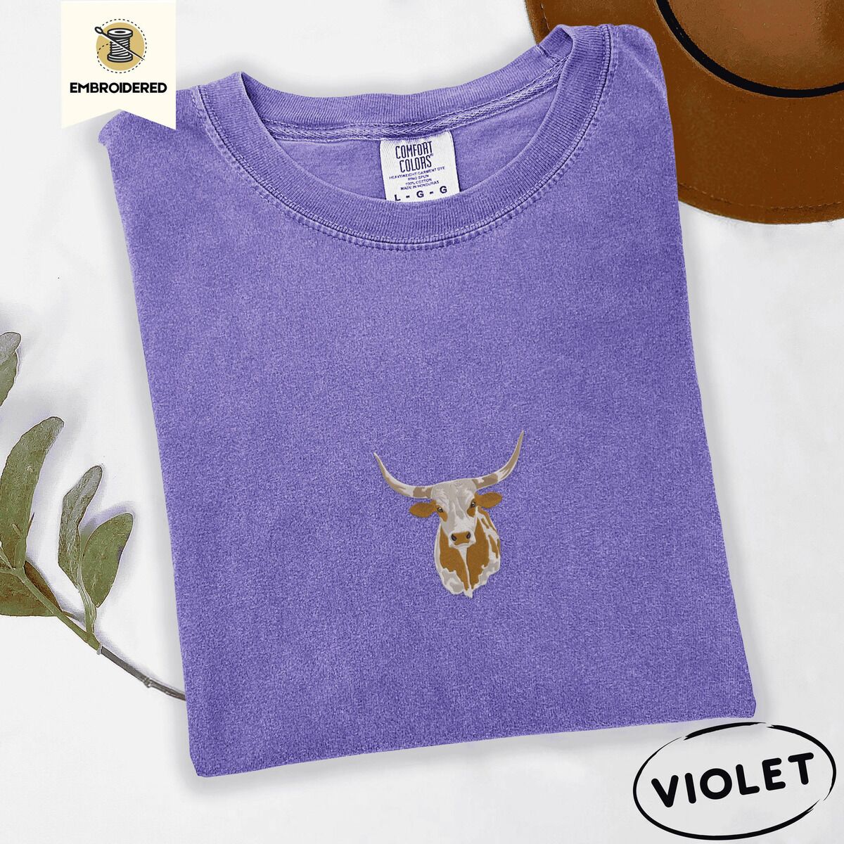 Longhorn Cow Shirt – Violet Violet Comfort Colors T-shirt embroidered with a copper and cream longhorn steer head with long curved horns