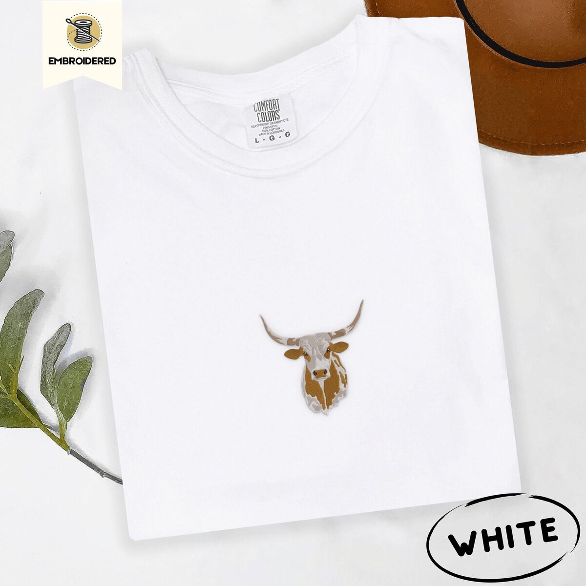 Longhorn Cow Shirt – White White Comfort Colors T-shirt embroidered with a copper and cream longhorn steer head with long curved horns