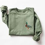Mallard crewneck in Military Green laid flat with a rolled sleeve, embroidered with a standing drake mallard with a green head, orange bill, chestnut chest and grey wing on the left chest