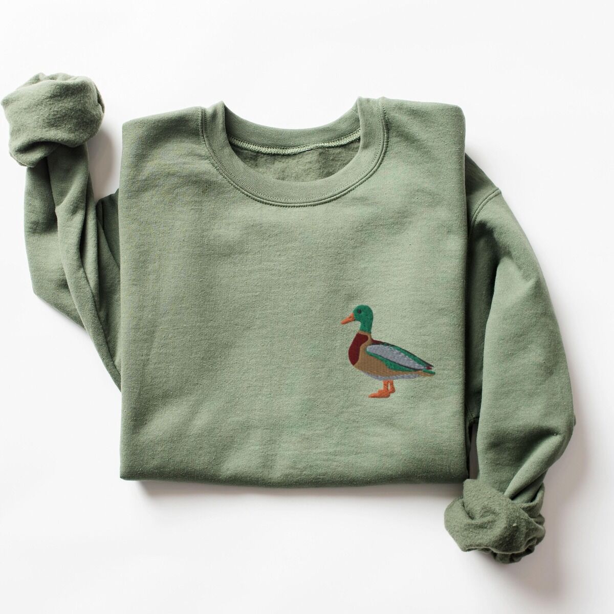 Mallard Crewneck – Military Green Mallard crewneck in Military Green laid flat with a rolled sleeve, embroidered with a standing drake mallard with a green head, orange bill, chestnut chest and grey wing on the left chest