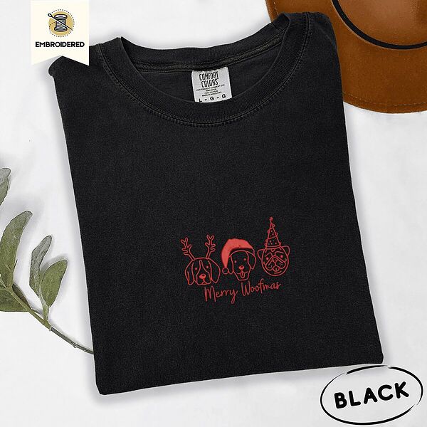 Black Comfort Colors T-shirt embroidered with three red line-art dog faces in Christmas hats above Merry Woofmas script