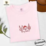 Blossom Comfort Colors T-shirt embroidered with three red line-art dog faces in Christmas hats above Merry Woofmas script