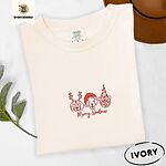 Ivory Comfort Colors T-shirt embroidered with three red line-art dog faces in Christmas hats above Merry Woofmas script