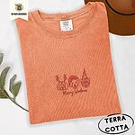 Terracotta Comfort Colors T-shirt embroidered with three red line-art dog faces in Christmas hats above Merry Woofmas script