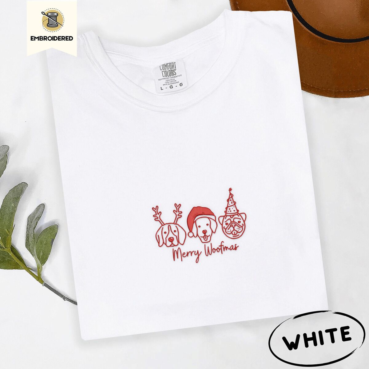 Merry Woofmas Shirt – White White Comfort Colors T-shirt embroidered with three red line-art dog faces in Christmas hats above Merry Woofmas script