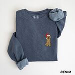 Denim crewneck sweatshirt laid flat, embroidered with a small goldendoodle in a Santa hat on the left chest