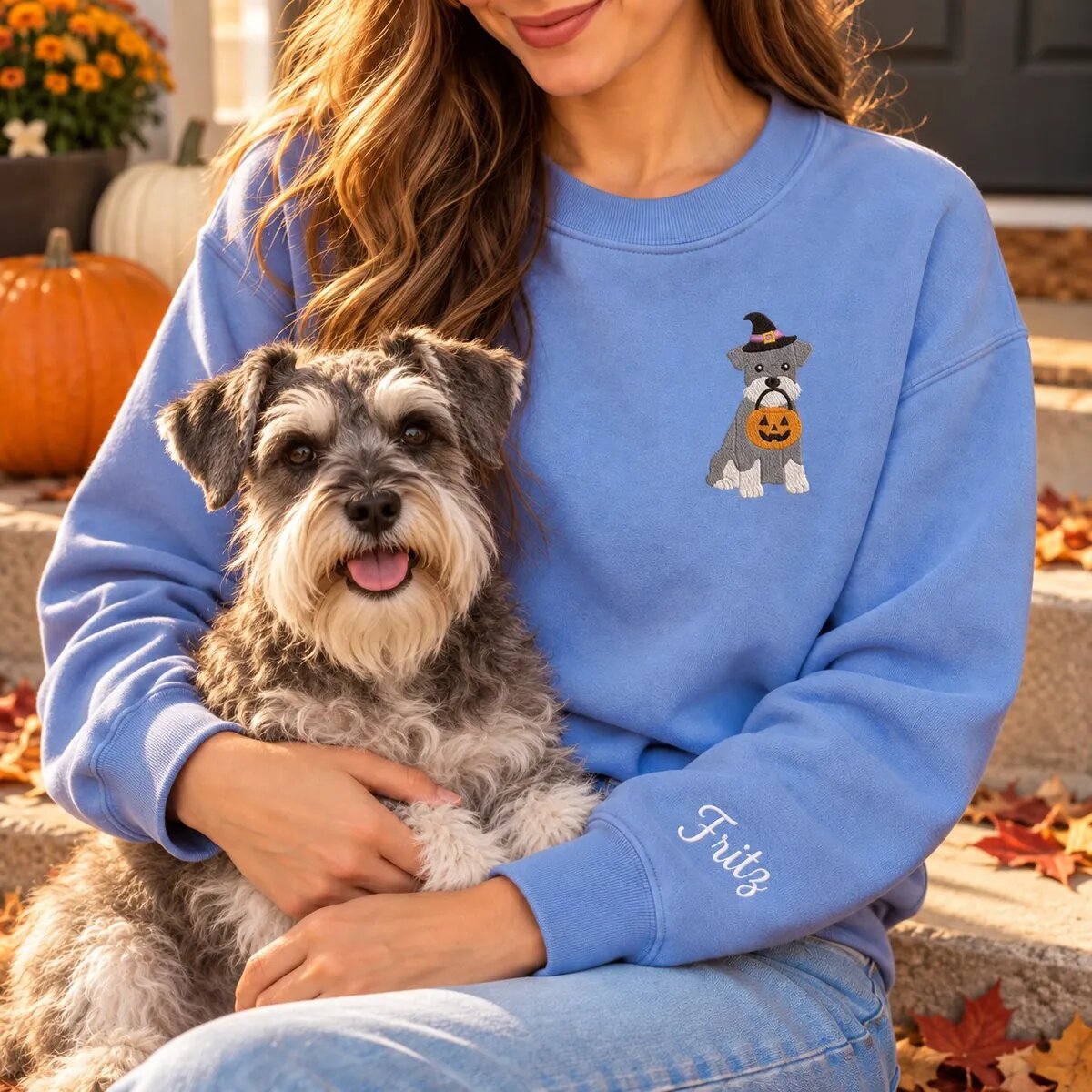 Miniature Schnauzer Mom Halloween Sweatshirt Worn Miniature Schnauzer mom wearing the Heather Deep Royal Halloween sweatshirt with her Miniature Schnauzer on a fall porch