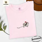 Blossom Comfort Colors T-shirt embroidered with a tricolor Papillon in a Santa hat holding the plug of a string of Christmas lights in its mouth