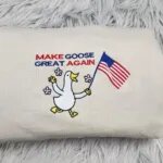 Close-up of the Make Goose Great Again embroidery, a marching goose with a U.S. flag and pink flowers