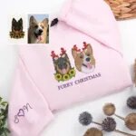 Light pink pet face Christmas sweatshirt with two dog portraits in red antlers and sleeve initials with a heart