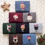 Eight custom dog Christmas sweatshirts in different colors with embroidered dog portraits, holiday hats and names