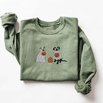 Military Green crewneck sweatshirt laid flat on a white background, embroidered with a pit bull and a black lab in ghost sheets holding jack-o'-lantern buckets