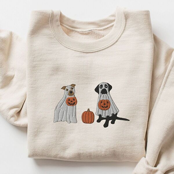 Sand crewneck sweatshirt laid flat with a rolled cuff, embroidered with a pit bull and a black lab in ghost sheets holding jack-o'-lantern buckets
