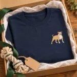 Navy T-shirt with the small pit bull embroidery folded in a kraft gift box with a rope dog toy